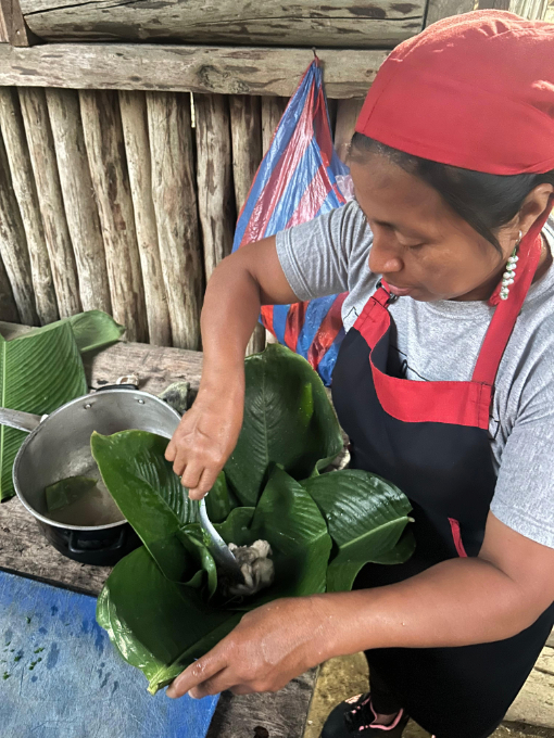 Preparing "Maito Humado" - a meal of fish or chicken wrapped in a banana leaf and cooked over a wood fire.