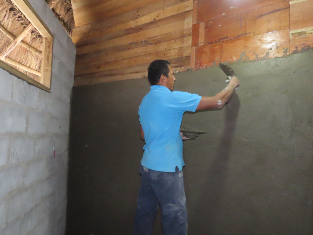 A man plastering a wall